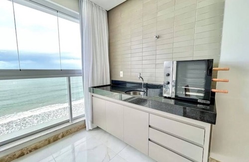 Praia do Morro Apartment | Beachfront apartment in Praia do Morro with air conditioning and barbecue.