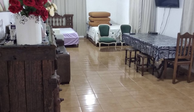 Country house surrounded by lush greenery, birdsong.