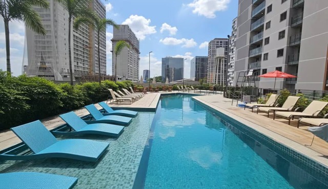 Modern studio apartment with ocean view, pool, and leisure facilities.